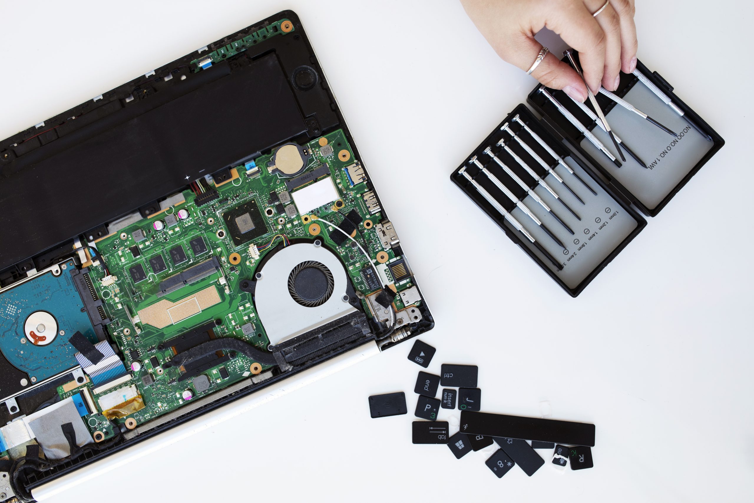 young-woman-cleaning-her-laptop-key-board